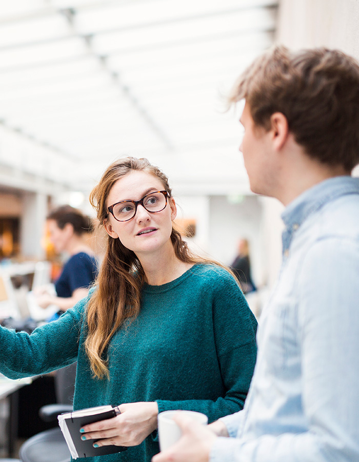 colleagues discussing a project in a modern office ABB2P7P